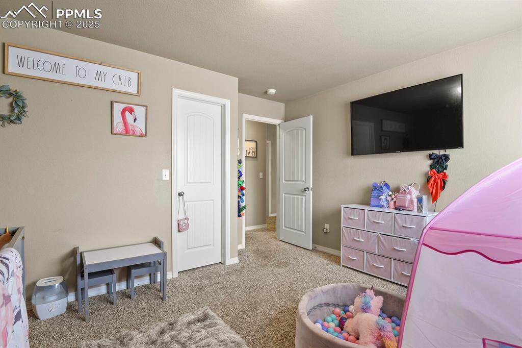 Bedroom with carpet flooring and baseboards