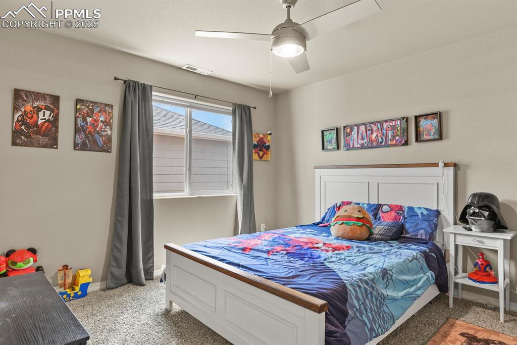 Bedroom featuring light carpet and ceiling fan