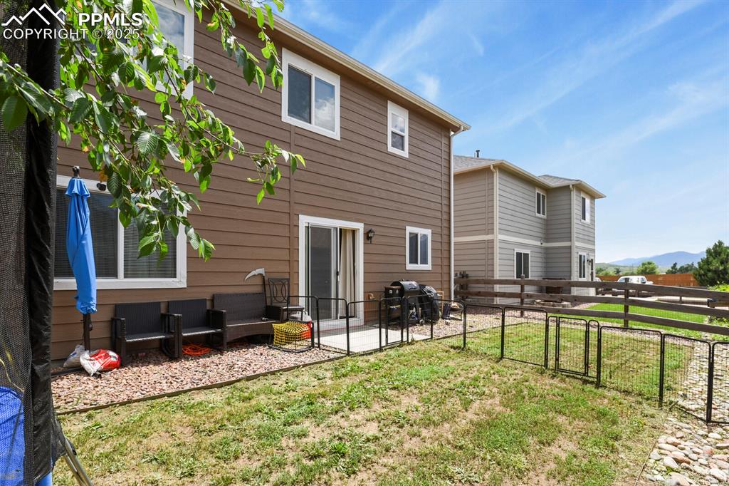 Rear view of property featuring a patio, a gate, and a mountain view