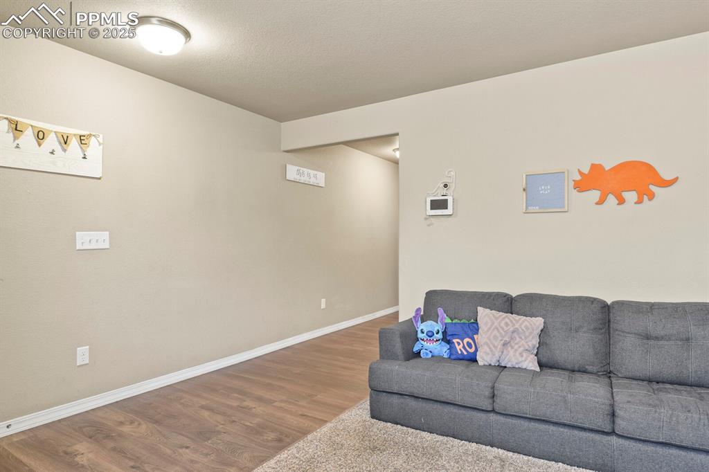 Living area with wood finished floors and baseboards