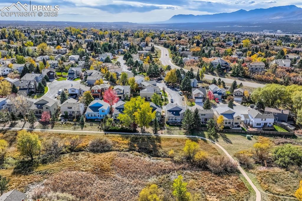 Aerial perspective of suburban area featuring a mountainous background