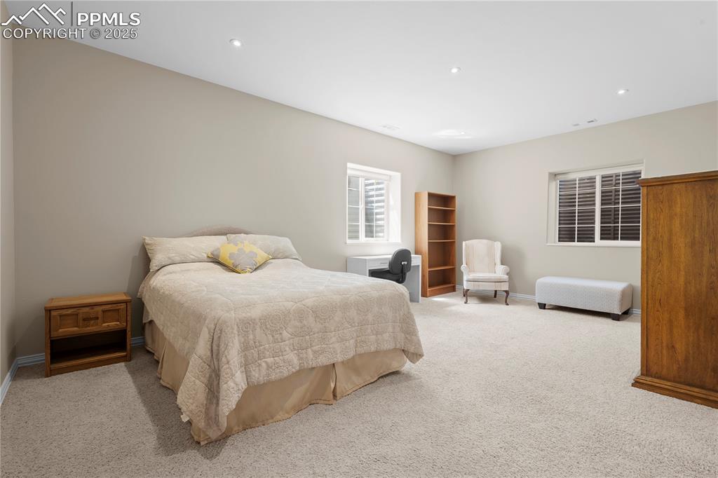 Carpeted bedroom featuring baseboards and recessed lighting