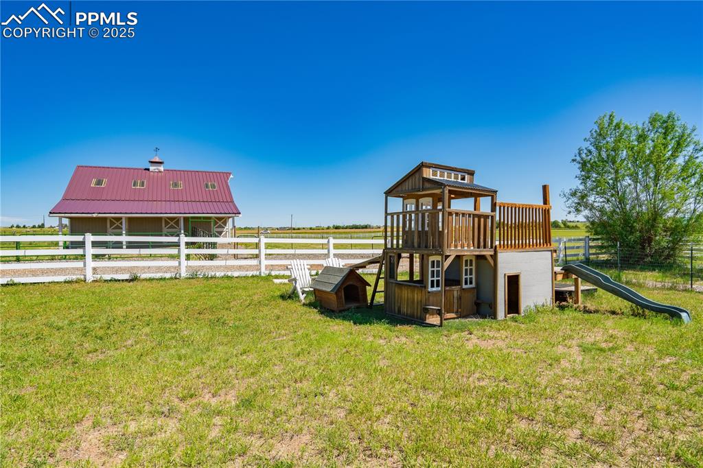 View of yard with a playground and a water view