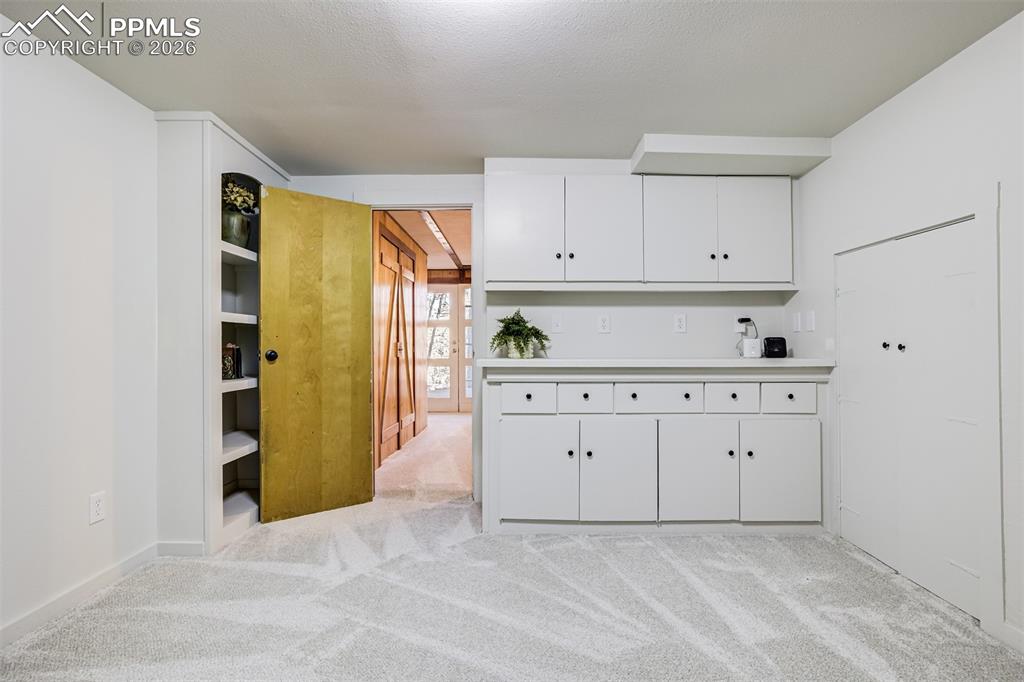 Office in basement with built ins. Would make a great craft room/playroom, gym or office