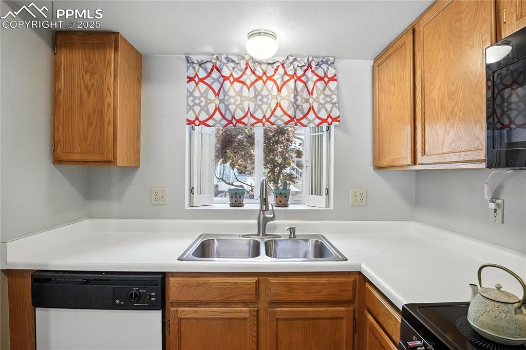 Kitchen is light and bright with a lovely view of the plum tree in the front yard