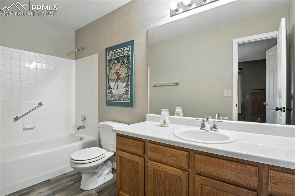 Secondary bathroom on upper level, private for second bedroom with shower bar for accessibility needs.