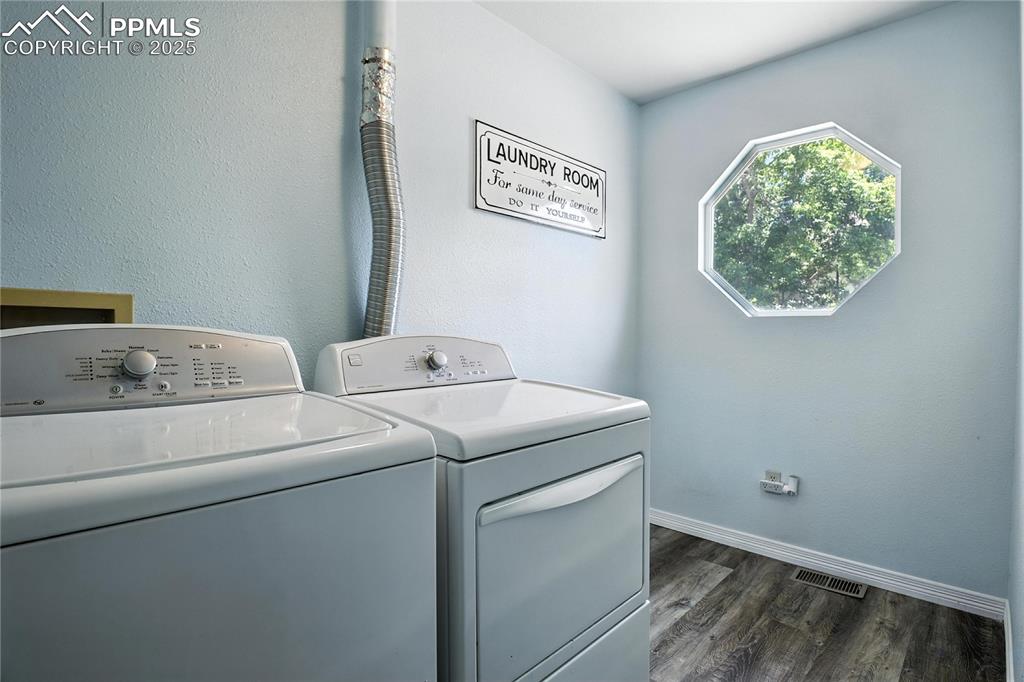 Laundry room featuring washing machine, clothes dryer and window