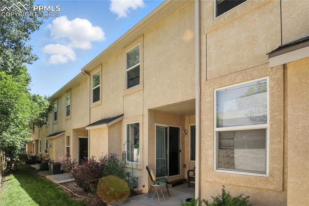 Back of property featuring stucco siding and a patio area