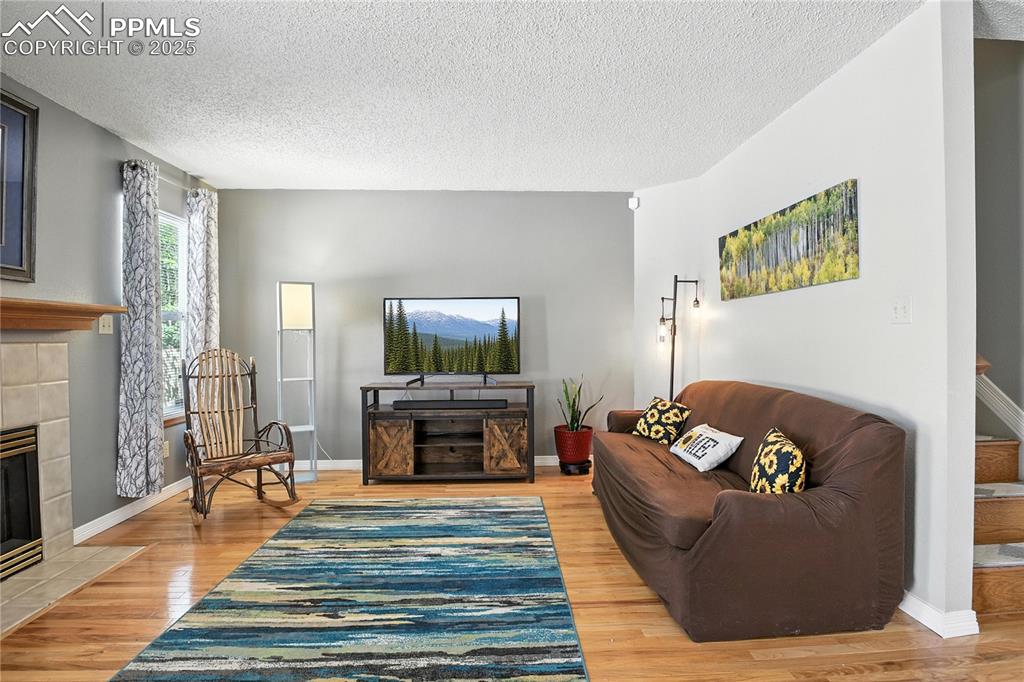 Freshly painted walls, newer wood laminate flooring, and fireplace. 