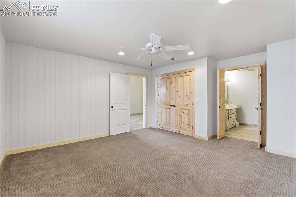 Unfurnished bedroom with recessed lighting, carpet floors, ceiling fan, and ensuite bath