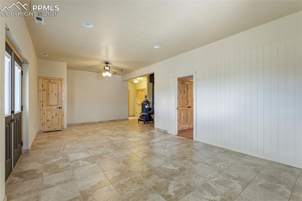 Spare room with ceiling fan and baseboards
