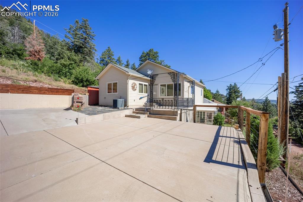 View of front facade featuring a patio and a wooden deck