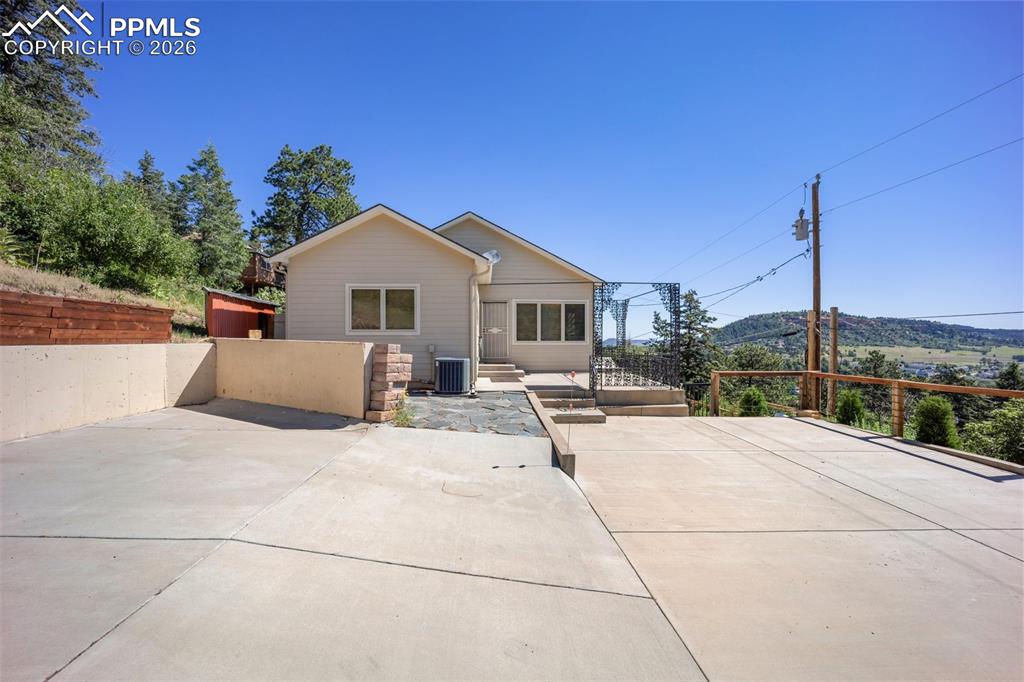 Rear view of house featuring a patio area and a mountain view