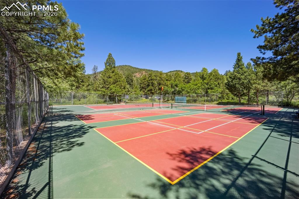 View of tennis court featuring a mountain view