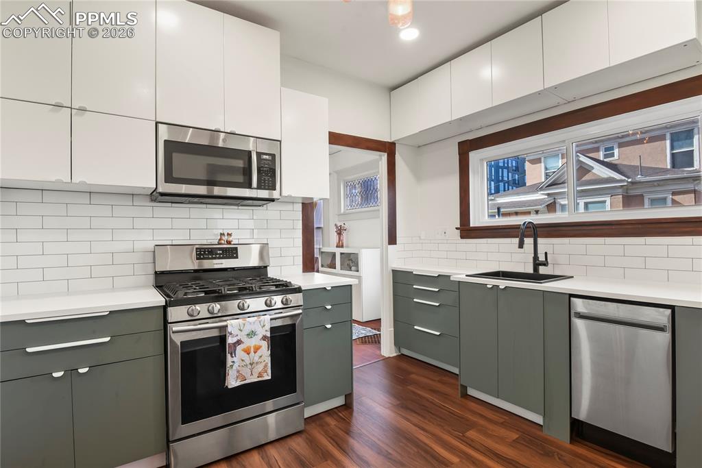 Updated kitchen showcases sleek modern cabinetry, fresh paint, and stainless steel appliances