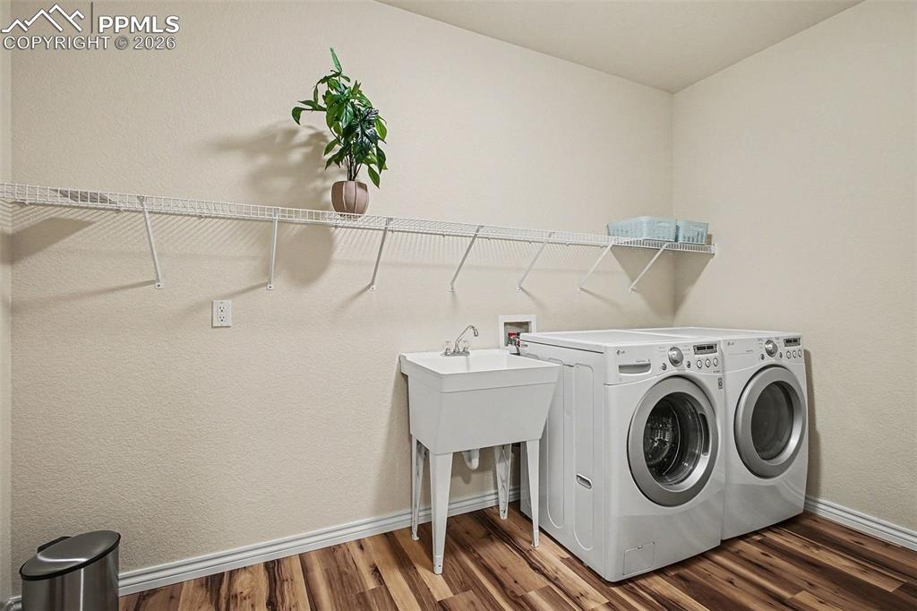 Large laundry room with sink and storage