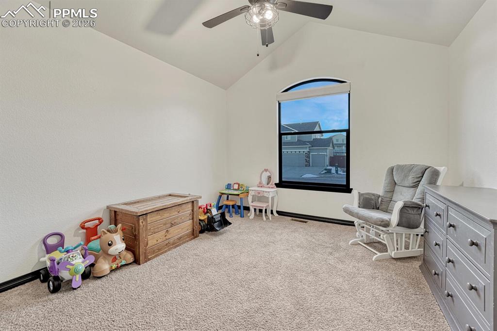Game room featuring light carpet, lofted ceiling, and ceiling fan