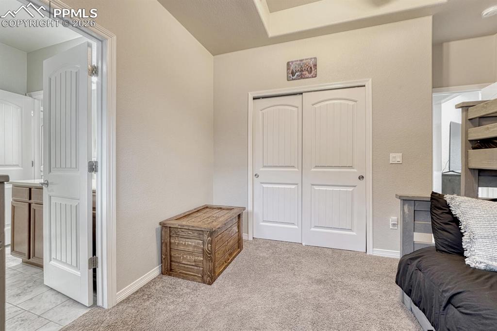 Sitting room with light colored carpet and baseboards