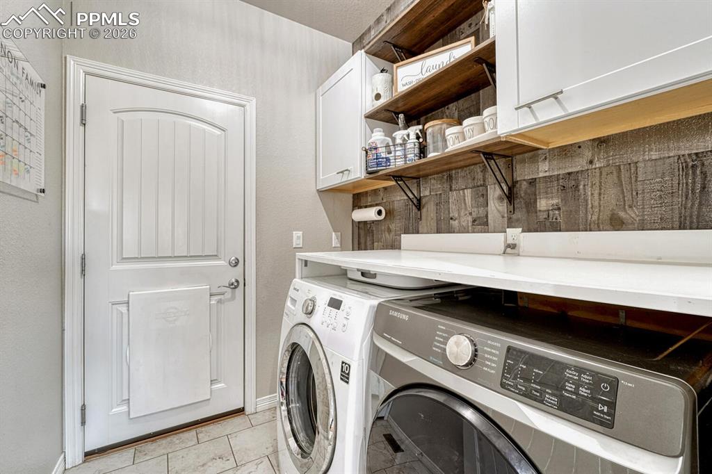 Laundry room featuring cabinet space and independent washer and dryer