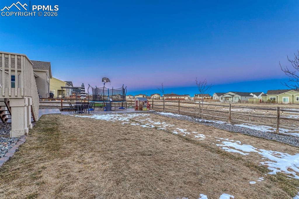 Yard at dusk with a residential view