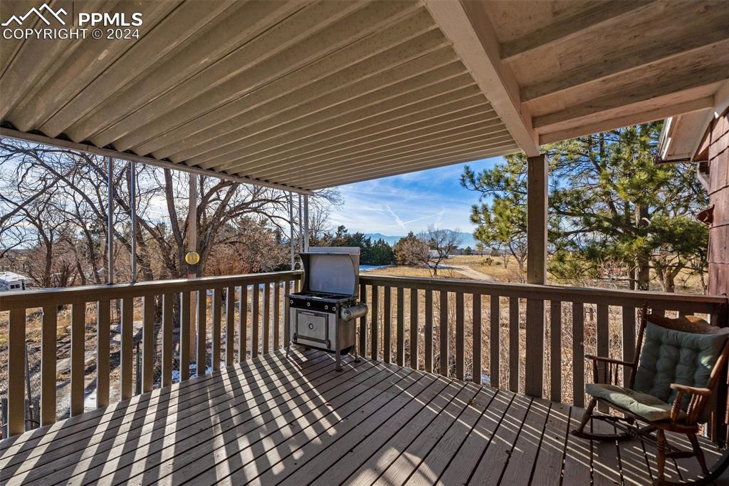 Covered deck off the sunroom with mountain views