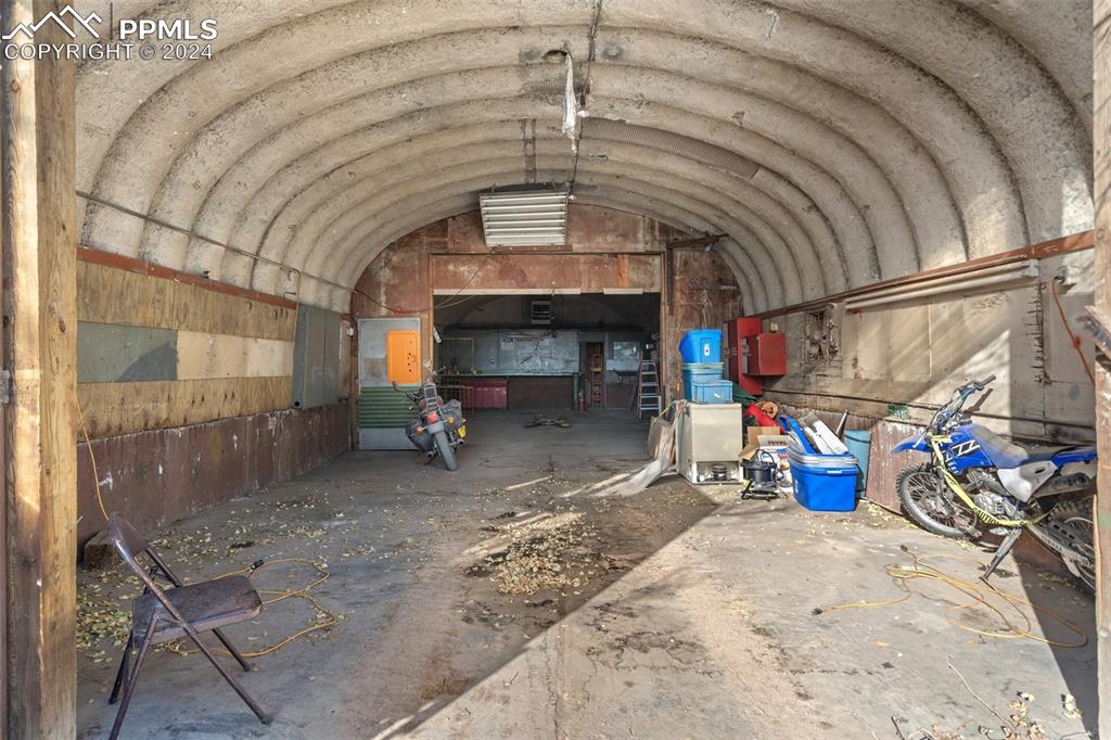 Large out building with car lift in the rear portion