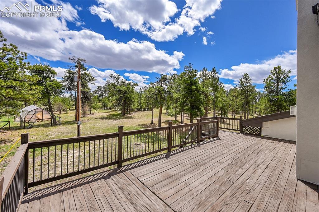 Primary Bedroom private Deck featuring views of pined property 