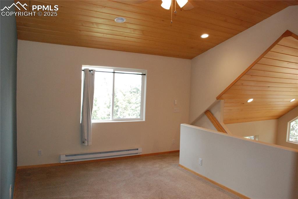 Loft which serves as second Bedroom with wood cathedral ceiling.