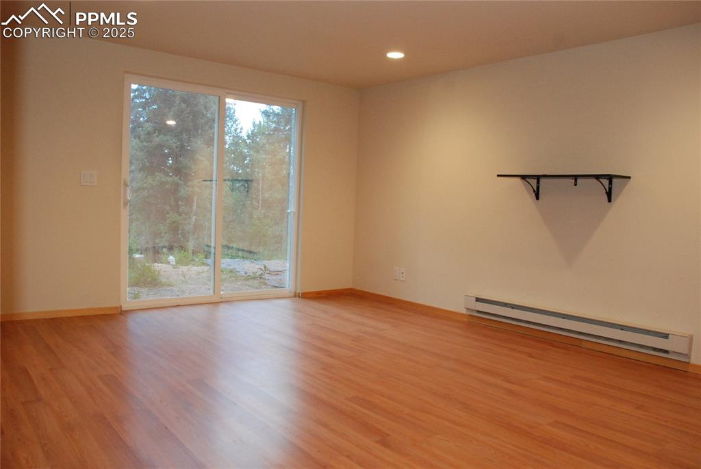 In the basement you will find the spacious Primary Bedroom featuring new wood laminate flooring and a walk-out sliding glass door.