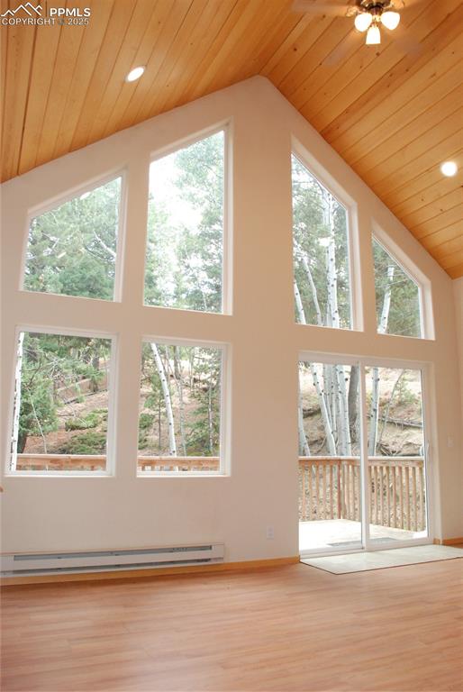 Soaring wood finished cathedral ceilings and new wood laminate floors are accented with a wall of windows in the open living area.
