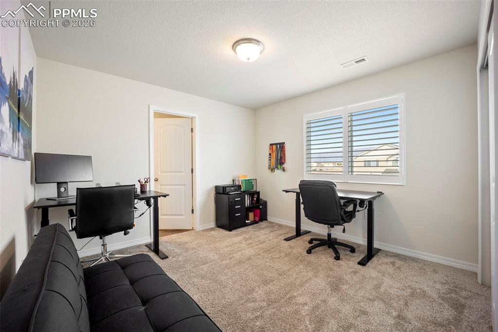 Upper bedroom used as office with mountain views