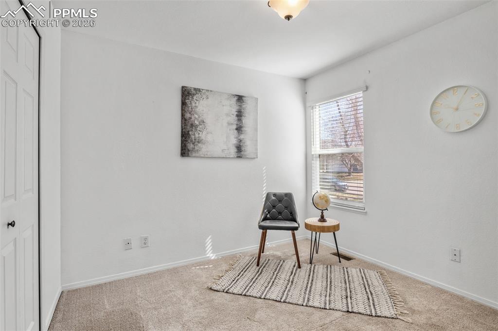 Sitting room with carpet flooring