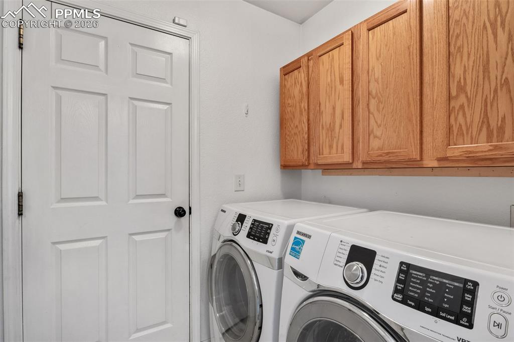 Laundry room with cabinet space and washing machine and dryer