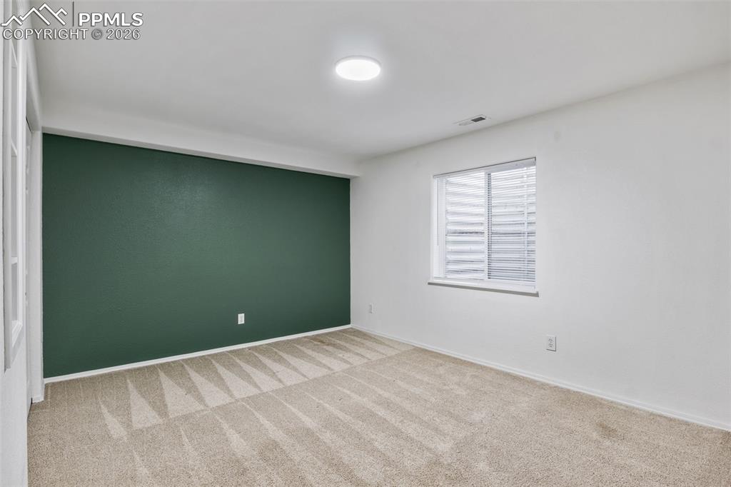 Unfurnished room with light carpet and baseboards