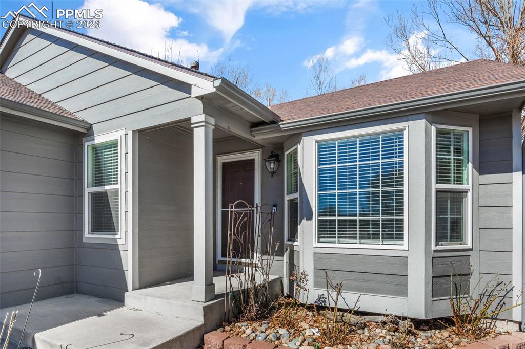 Property entrance with a shingled roof