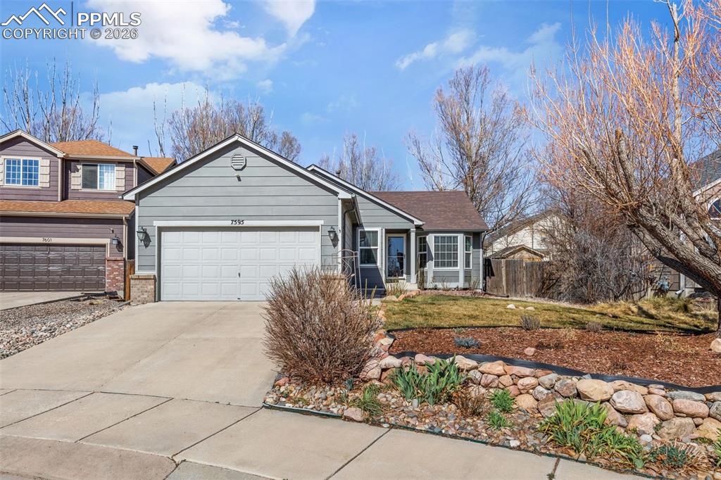 View of front facade featuring concrete driveway, a garage, and brick siding