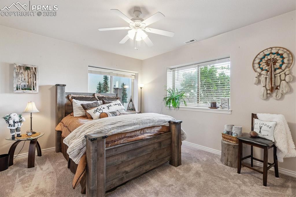 Bedroom featuring ceiling fan and light carpet
