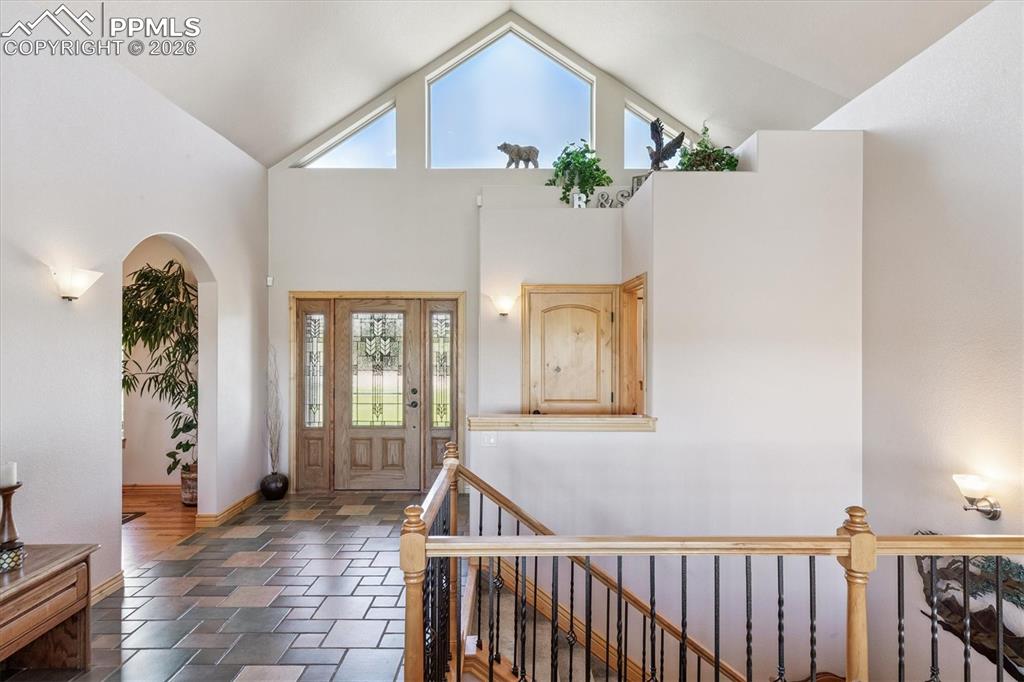 Foyer featuring high vaulted ceiling 