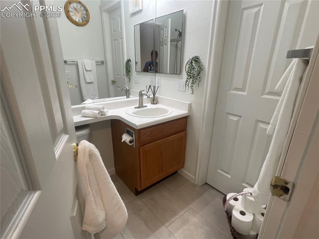 Bathroom featuring vanity and light tile patterned flooring