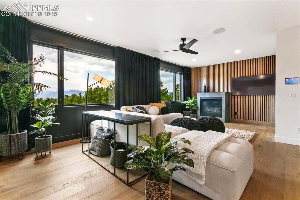 Another fireplace and TV accent the family room that boasts "Top of the World" views  of Pikes peak, Air Force Academy and the entire Front Range.