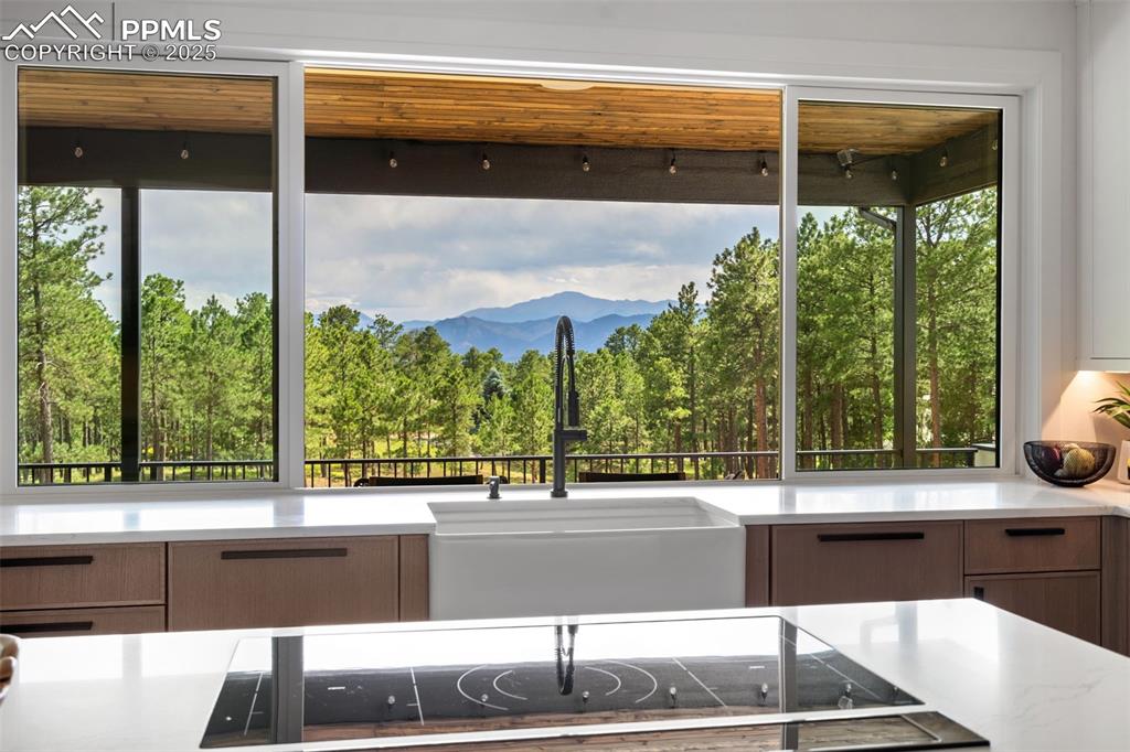 Enjoy amazing Pikes Peak Views from the Kitchen pass thru window! A Family and Entertainers dream!