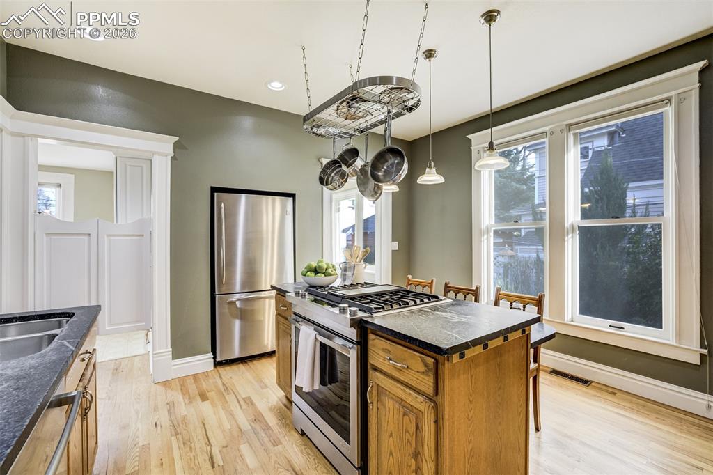 Kitchen offers abundant light and functionality while maintaining historic touches