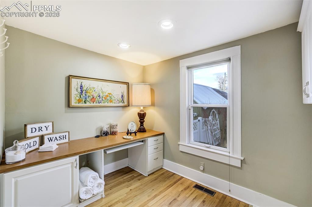 Large main level laundry room features space for office and crafts