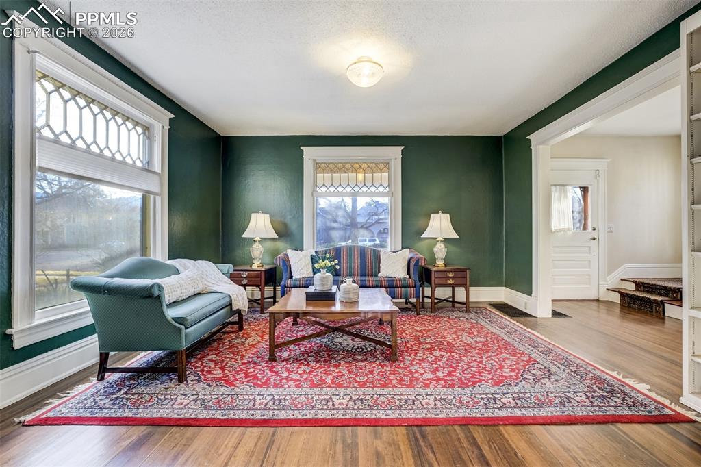 Living Room off main entry way - gorgeous light and original wood floors!