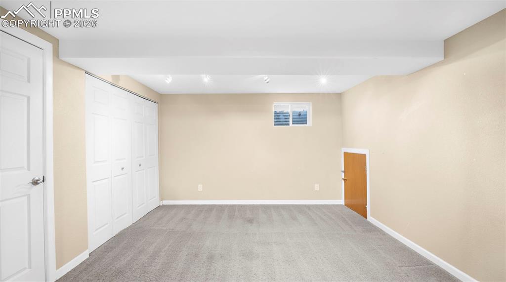 Unfurnished bedroom with light colored carpet and a closet