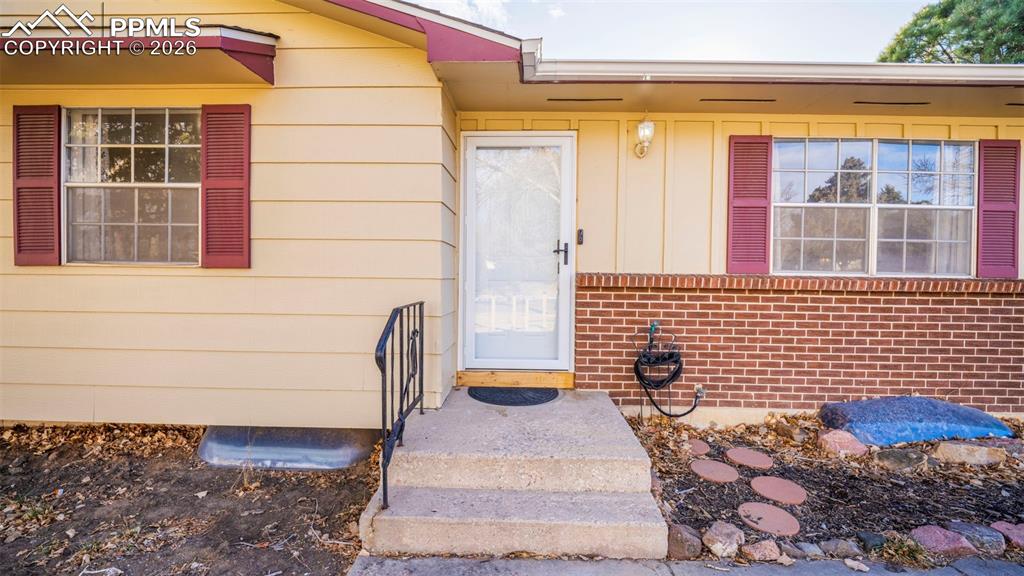 Property entrance with board and batten siding