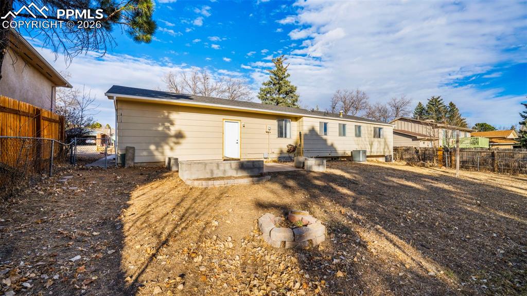 Rear view of house with a patio and a fenced backyard