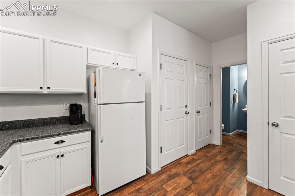 Kitchen looking towards 1/2 bath, garage access, and pantry.
