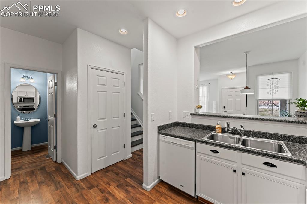 Kitchen looking to half bathroom and utility closet.