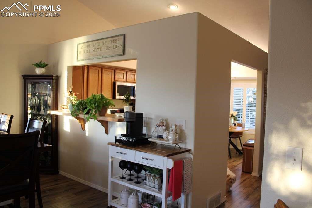 Hall with dark wood-style floors and baseboards